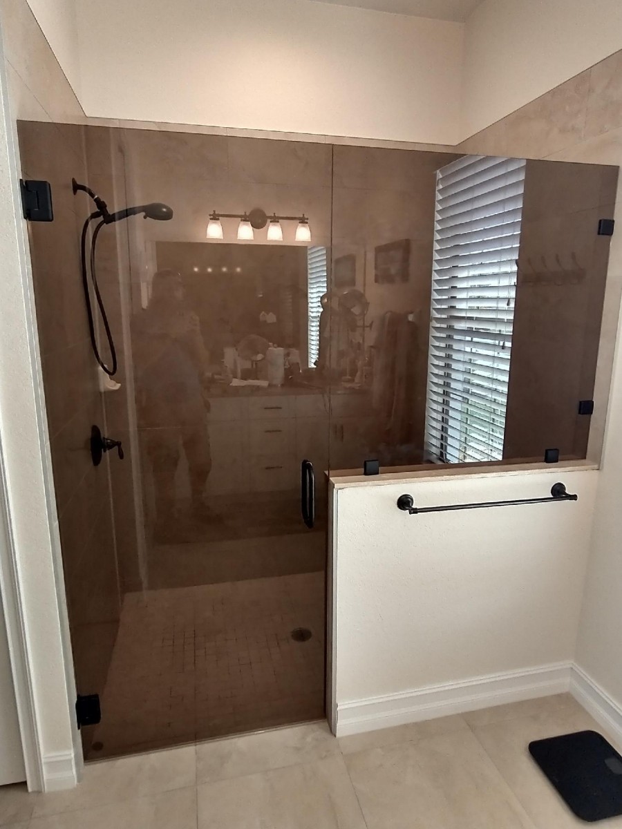 Lemon-Bay-Glass_Bronze-Glass-Shower-Frameless Enclosures_Hinged-shower-door-and-panel_042822