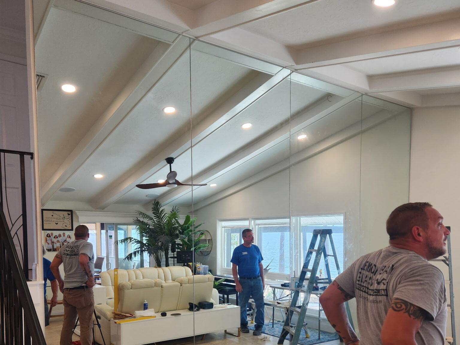 Custom Wall of Mirrors Installed by Lemon Bay Glass. Floor to ceiling soaring mirrors reflecting light and openess.